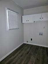 laundry area with dark wood-style floors, hookup for a washing machine, cabinet space, and baseboards