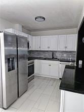 kitchen featuring stainless steel fridge with ice dispenser, tasteful backsplash, oven, and dark countertops