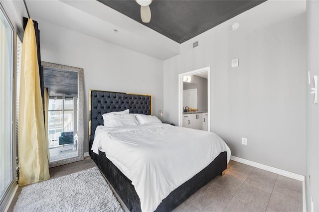 bedroom with visible vents, baseboards, ceiling fan, and ensuite bathroom