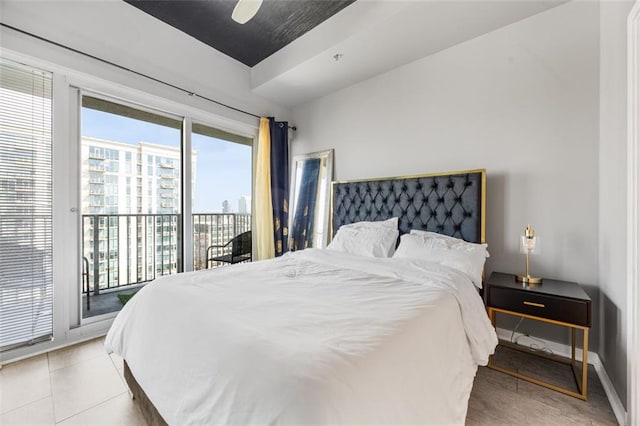 bedroom featuring light tile patterned floors, baseboards, a ceiling fan, and access to outside