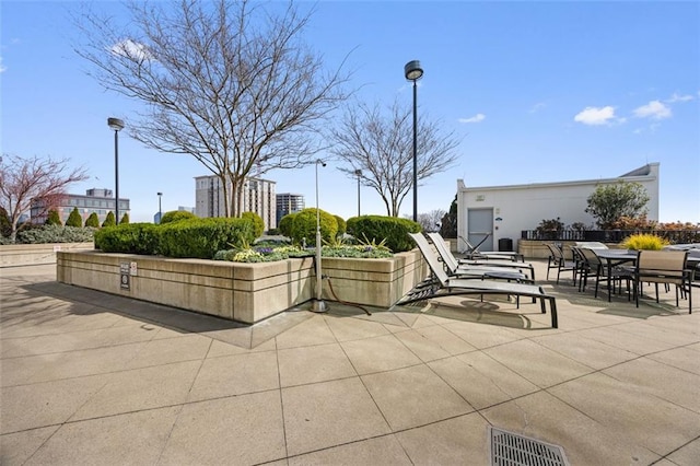 view of community featuring visible vents, outdoor dining area, and a patio area