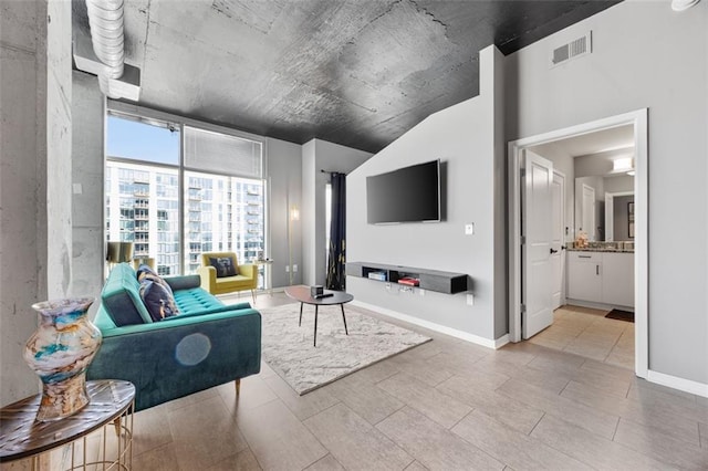 living area with visible vents, baseboards, and floor to ceiling windows