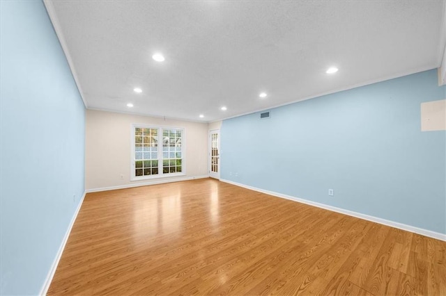 interior space with light wood-type flooring and crown molding