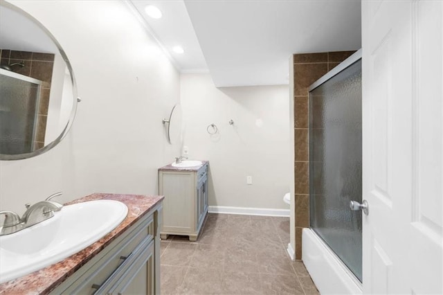 bathroom with tile patterned floors, vanity, and bath / shower combo with glass door