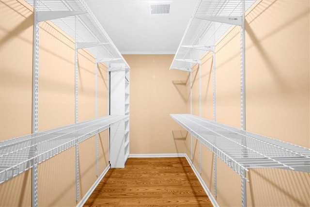 walk in closet featuring hardwood / wood-style floors