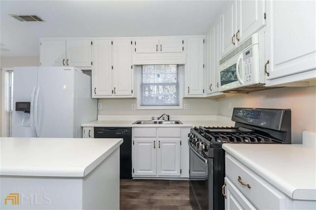 kitchen featuring black appliances, a sink, white cabinets, and light countertops