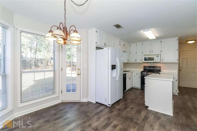 kitchen featuring white appliances, a chandelier, dark wood-style floors, light countertops, and white cabinetry
