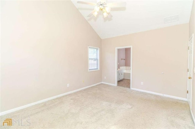 unfurnished bedroom featuring carpet floors, baseboards, connected bathroom, high vaulted ceiling, and a ceiling fan