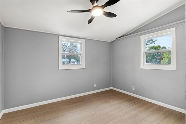 empty room featuring vaulted ceiling, ceiling fan, and light wood-type flooring