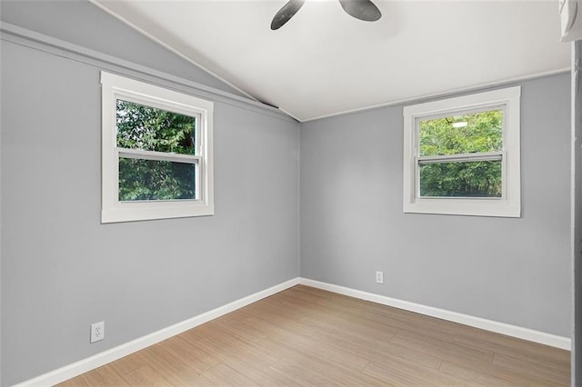 empty room with wood-type flooring and vaulted ceiling