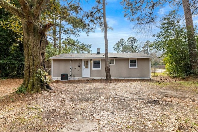 rear view of property with cooling unit