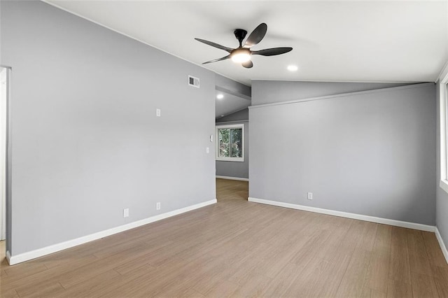 spare room with vaulted ceiling, ceiling fan, and light hardwood / wood-style floors