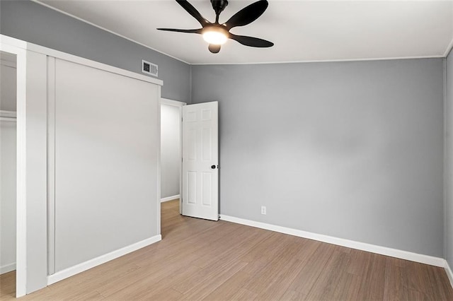 unfurnished bedroom with a closet, ceiling fan, and light wood-type flooring