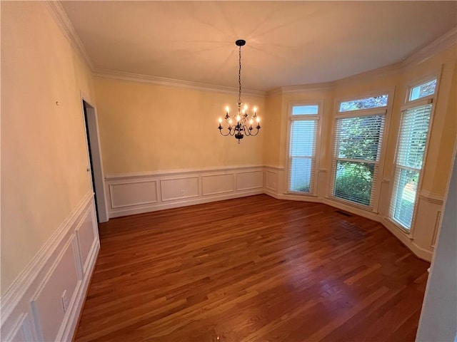 1595 Chadberry Way, Lawrenceville, GA 30043 - unfurnished dining area with a decorative wall, dark wood finished floors, a chandelier, ornamental molding, and a wainscoted wall