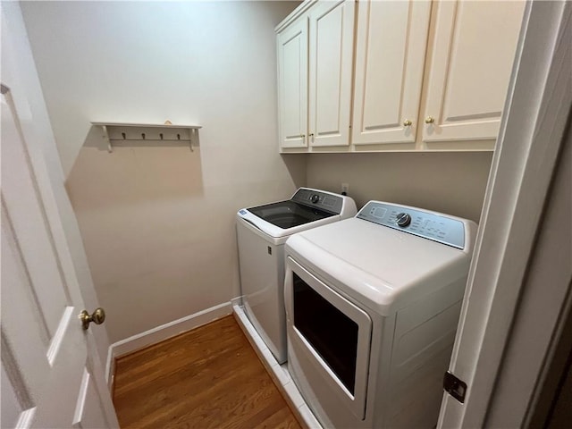 1595 Chadberry Way, Lawrenceville, GA 30043 - washroom featuring washer and clothes dryer, cabinet space, wood finished floors, and baseboards