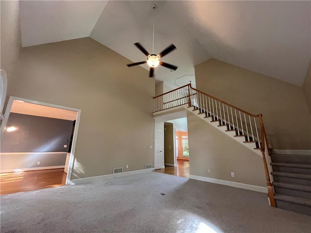 1595 Chadberry Way, Lawrenceville, GA 30043 - unfurnished living room featuring ceiling fan, carpet floors, stairway, and high vaulted ceiling