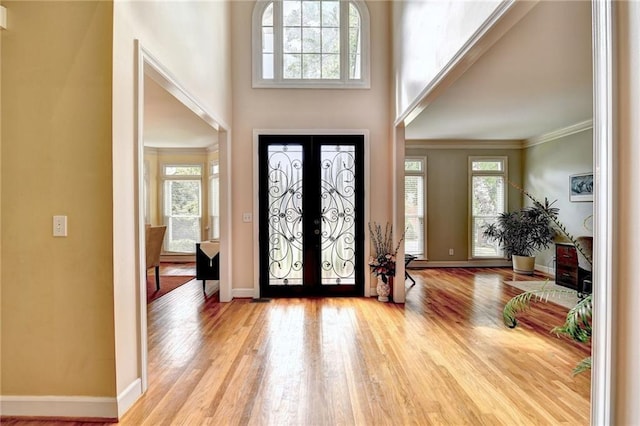 1595 Chadberry Way, Lawrenceville, GA 30043 - entryway featuring wood finished floors, baseboards, crown molding, and a towering ceiling