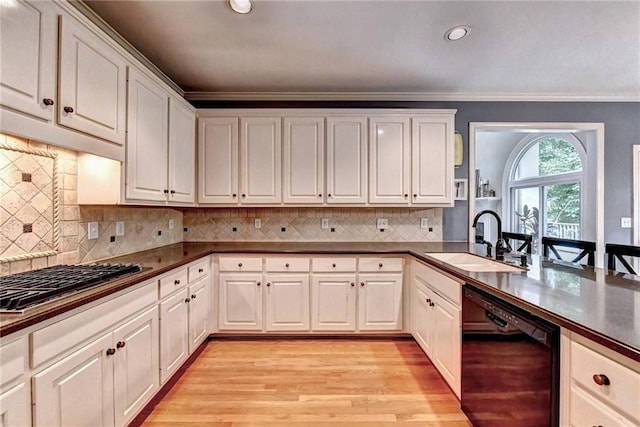 1595 Chadberry Way, Lawrenceville, GA 30043 - kitchen with black dishwasher, a sink, gas cooktop, light wood-type flooring, and white cabinetry