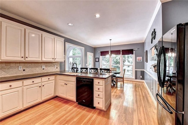 1595 Chadberry Way, Lawrenceville, GA 30043 - kitchen featuring black appliances, a sink, light wood finished floors, a peninsula, and dark countertops