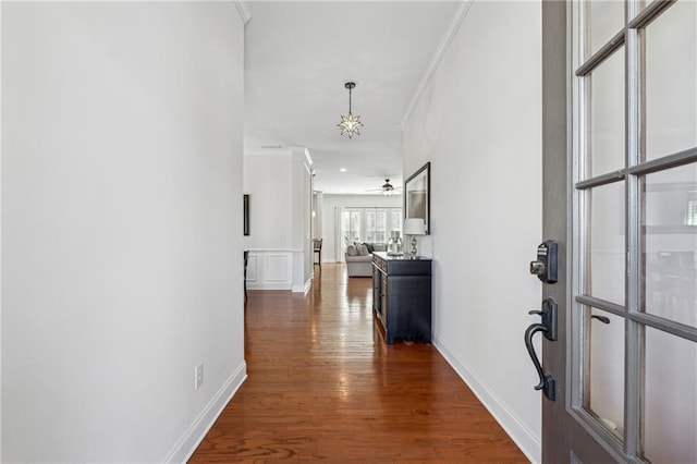 corridor featuring ornamental molding and dark hardwood / wood-style flooring