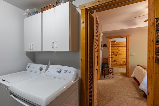 laundry room featuring separate washer and dryer, light carpet, ceiling fan, and cabinets