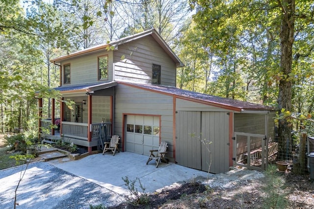 view of property exterior featuring a porch and a garage