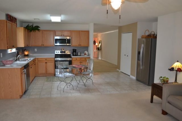 kitchen with light carpet, ceiling fan, stainless steel appliances, and sink