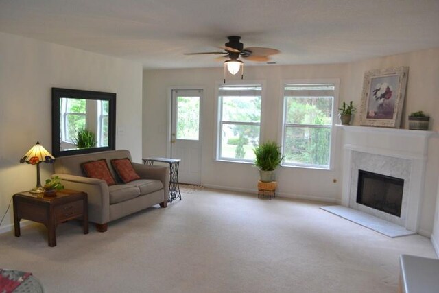 living room with ceiling fan and light colored carpet