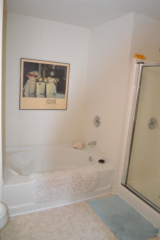 bathroom featuring shower with separate bathtub