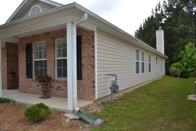 view of side of property with a lawn