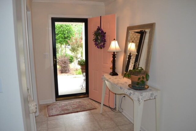 foyer entrance featuring crown molding