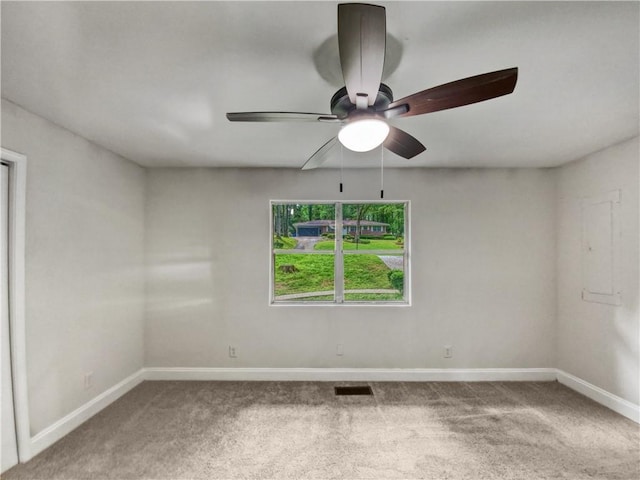 empty room with ceiling fan, carpet flooring, and electric panel