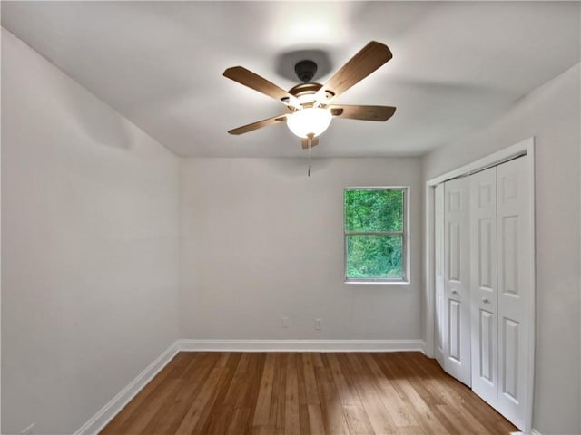 unfurnished bedroom with a closet, ceiling fan, and light wood-type flooring