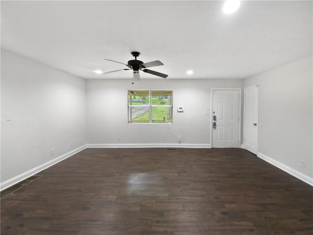 unfurnished room with ceiling fan and dark hardwood / wood-style flooring