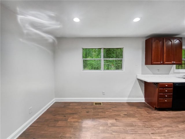 kitchen featuring dark brown cabinets, dishwasher, and wood-type flooring