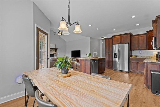 419 Highland Pointe Dr, Alto, GA 30510 - dining room featuring light wood finished floors, a fireplace, recessed lighting, a chandelier, and baseboards