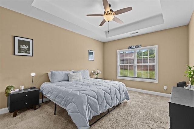 419 Highland Pointe Dr, Alto, GA 30510 - bedroom featuring a tray ceiling, light colored carpet, baseboards, and a ceiling fan