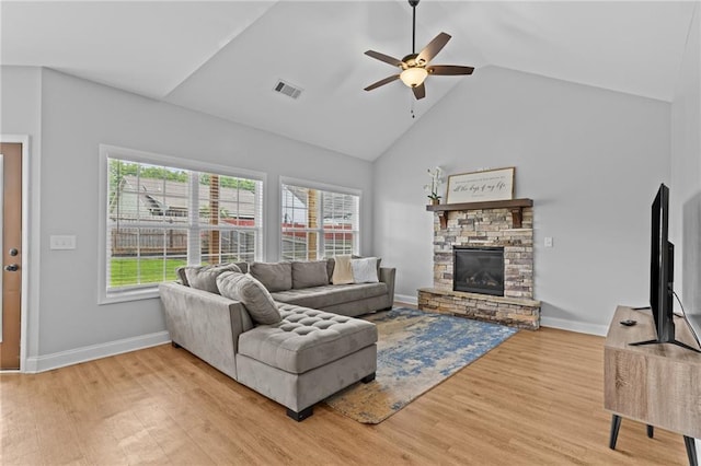 419 Highland Pointe Dr, Alto, GA 30510 - living area with a ceiling fan, light wood-type flooring, high vaulted ceiling, a stone fireplace, and baseboards
