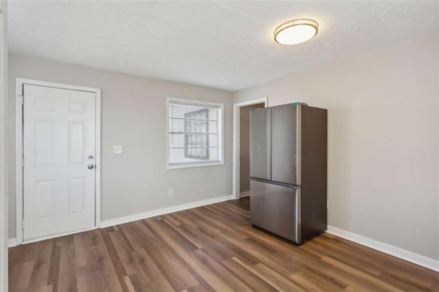 5119 NE Worsham St, Covington, GA 30014 - kitchen featuring freestanding refrigerator, wood finished floors, and a textured ceiling
