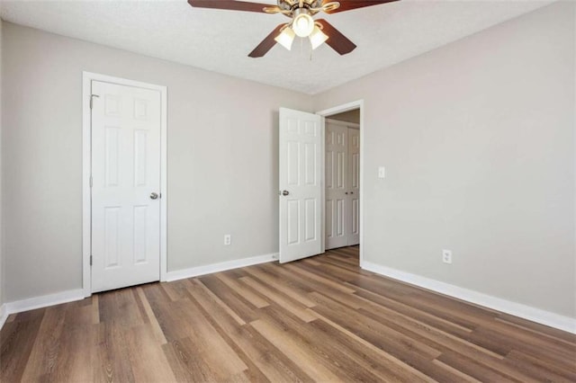 5119 NE Worsham St, Covington, GA 30014 - unfurnished bedroom featuring wood finished floors and a ceiling fan