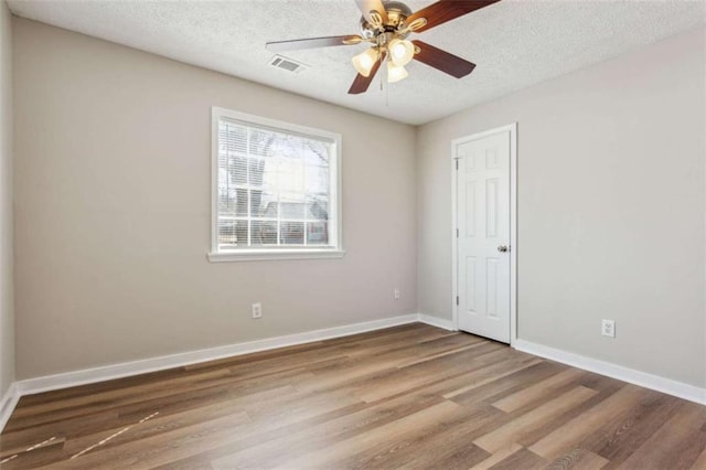 5119 NE Worsham St, Covington, GA 30014 - unfurnished room featuring wood finished floors, a textured ceiling, and a ceiling fan