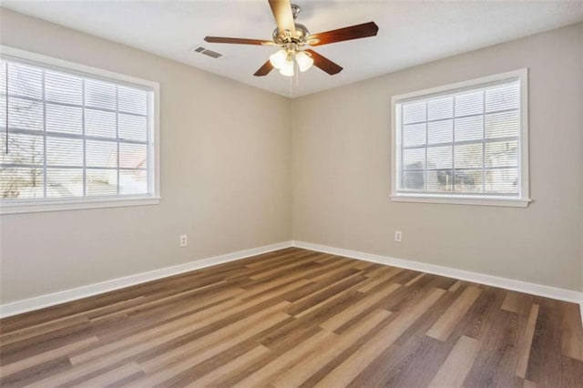 5119 NE Worsham St, Covington, GA 30014 - empty room featuring healthy amount of natural light, wood finished floors, and ceiling fan