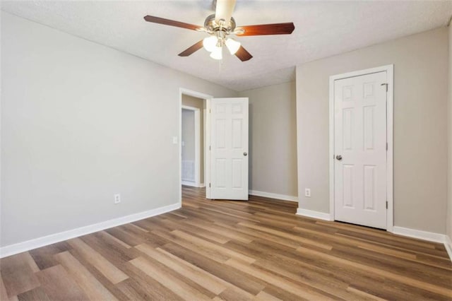 5119 NE Worsham St, Covington, GA 30014 - unfurnished bedroom featuring light wood-style flooring, a ceiling fan, and a textured ceiling
