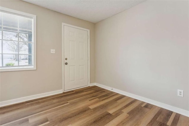 5119 NE Worsham St, Covington, GA 30014 - unfurnished room featuring wood finished floors and a textured ceiling
