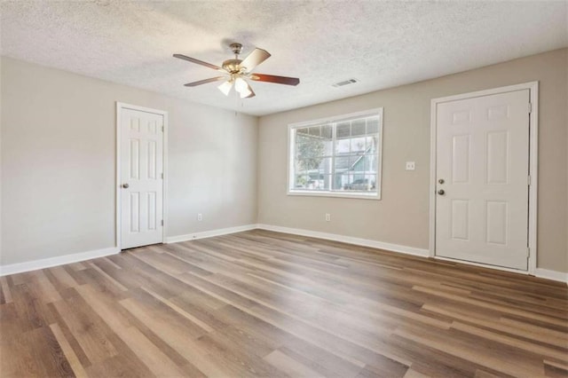 5119 NE Worsham St, Covington, GA 30014 - empty room with wood finished floors, ceiling fan, and a textured ceiling
