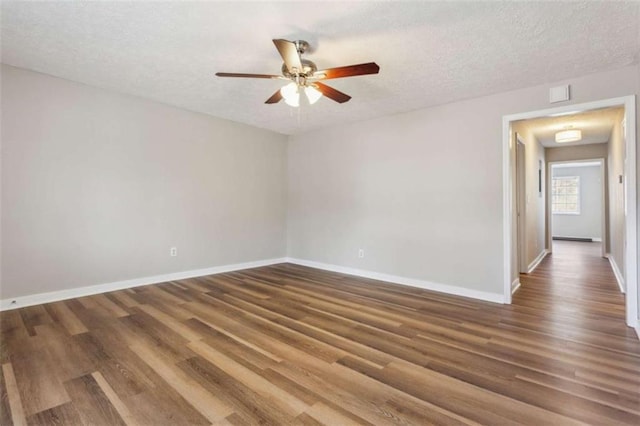 5119 NE Worsham St, Covington, GA 30014 - empty room with a ceiling fan, wood finished floors, and a textured ceiling
