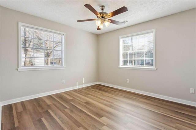 5119 NE Worsham St, Covington, GA 30014 - unfurnished room featuring wood finished floors, ceiling fan, and a textured ceiling