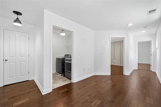 interior space with dark hardwood / wood-style floors and separate washer and dryer