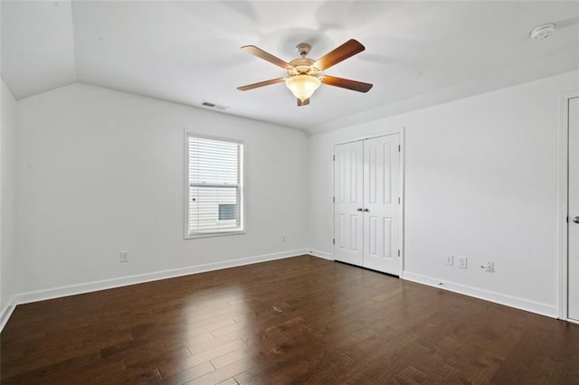 spare room with ceiling fan, dark hardwood / wood-style flooring, and vaulted ceiling