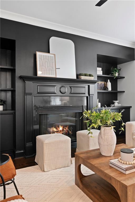 details featuring built in shelves and crown molding